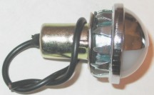 1979 Ford Bronco - A close-up view of a chrome and white light bulb assembly with black wires.