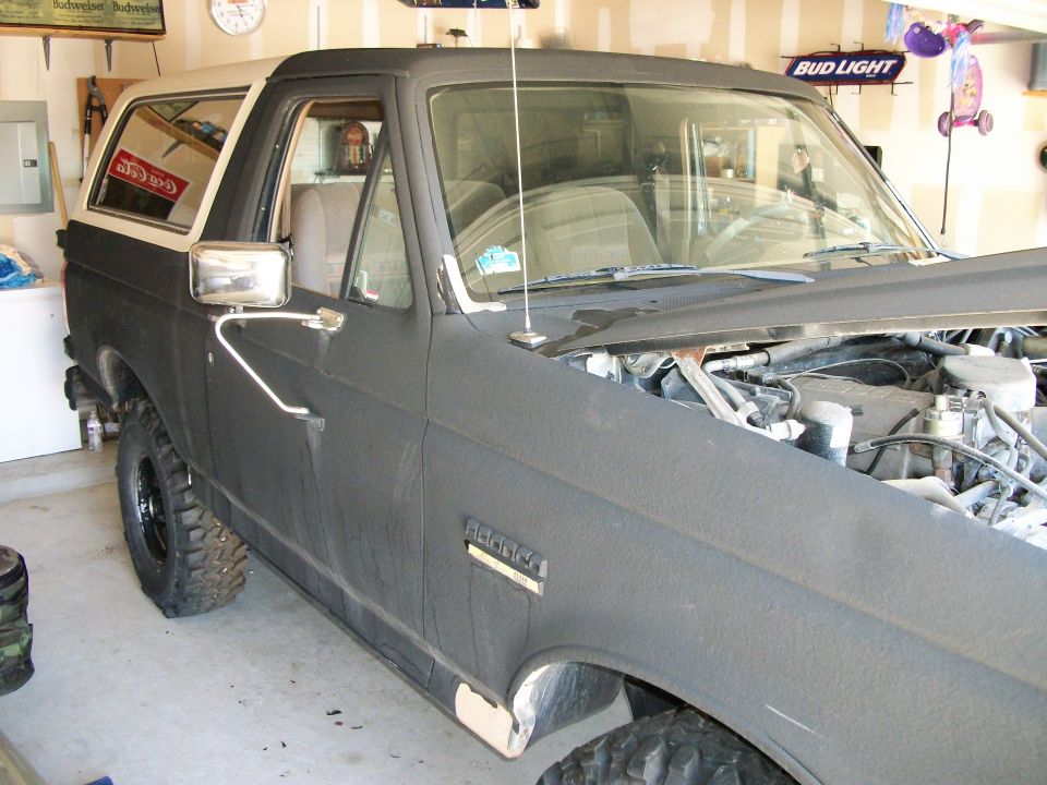 Black 1990 Ford Bronco, 3/4 front view, showing engine bay