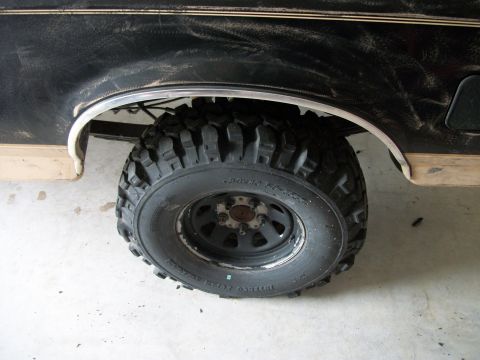 1990 Ford Bronco - Close-up of the rear wheel and fender of a 1990 Ford Bronco.