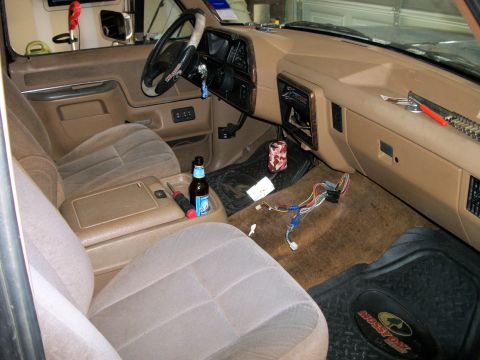 1990 Ford Bronco - The interior of a 1990 Ford Bronco shows exposed wiring and tools, suggesting recent work.
