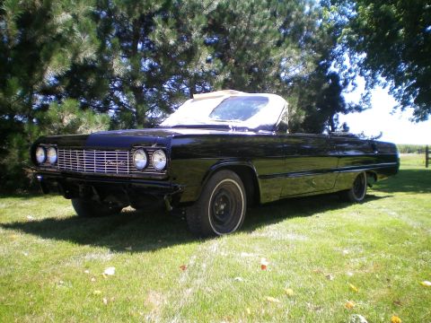 1964 Chevrolet Impala - This 1964 Chevrolet Impala convertible is parked on a grassy lawn under trees.