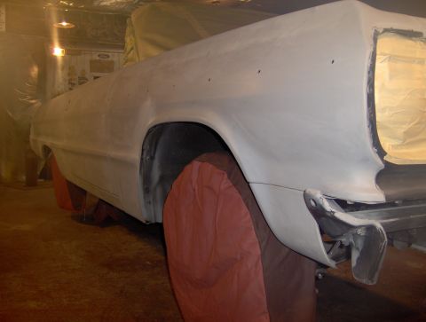 1964 Chevrolet Impala - A 1964 Chevrolet Impala is being prepped for paint, showing its rear quarter panel and taped-off taillight area.