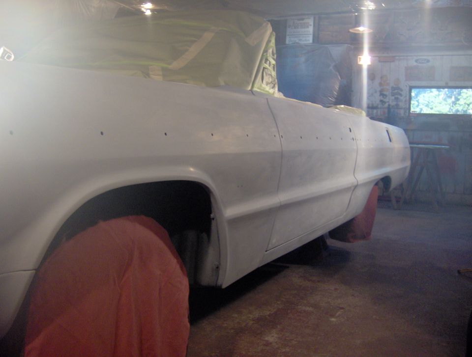 Side view of a 1964 Chevrolet Impala convertible in white primer