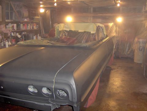 1964 Chevrolet Impala - A car is being prepped for paint in a cluttered garage with lights overhead.
