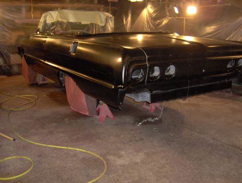 1964 Chevrolet Impala - A black car is parked outdoors at night.