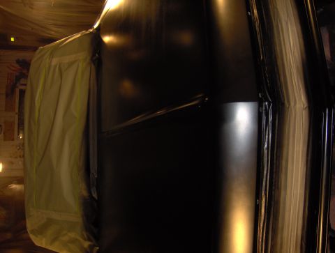 1964 Chevrolet Impala - A car door and interior panel are visible, with a tarp covering part of the vehicle.