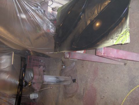 1964 Chevrolet Impala - Car part is covered in plastic sheeting and tape while being painted.