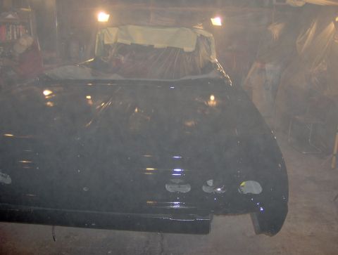 1964 Chevrolet Impala - Car body undergoing work in a garage, covered with plastic sheeting.