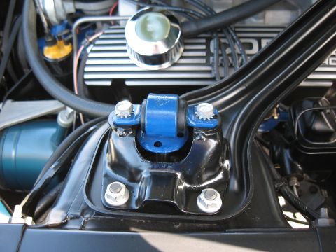 1968 Shelby GT500 - Close-up of the engine bay of a 1968 Shelby GT500, highlighting a blue strut mount and chrome accents.