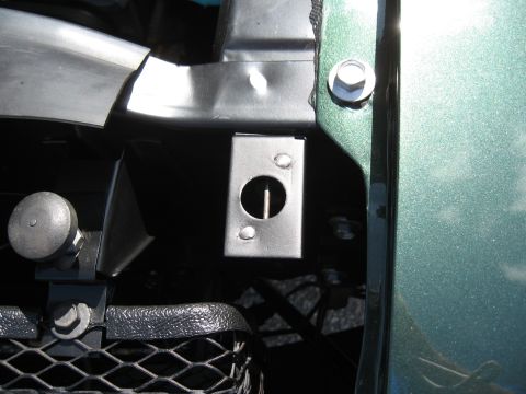 1968 Shelby GT500 - This metal bracket is part of the car's front-end assembly, located near the grille.