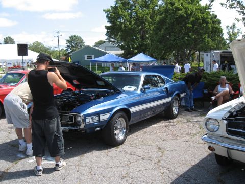 1968 Shelby GT500 - A blue 1969 Shelby GT500 is displayed with its hood open at an outdoor car show.