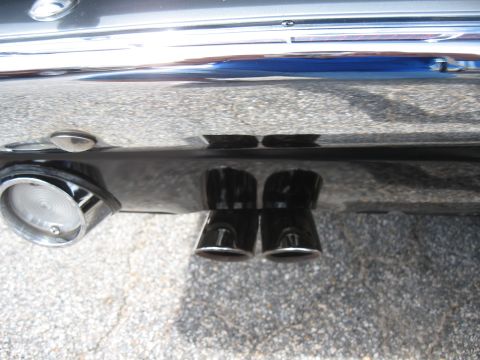 1968 Shelby GT500 - Close-up of the rear of a 1968 Shelby GT500, highlighting its distinctive dual exhaust pipes and round taillight.