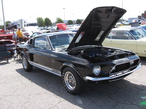 1968 Shelby GT500 - Black 1968 Shelby GT500 at a car show, hood raised to display the engine bay.