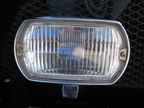 1968 Shelby GT500 - A close-up view of a Lucas brand headlight, mounted on a vehicle with a black grille.