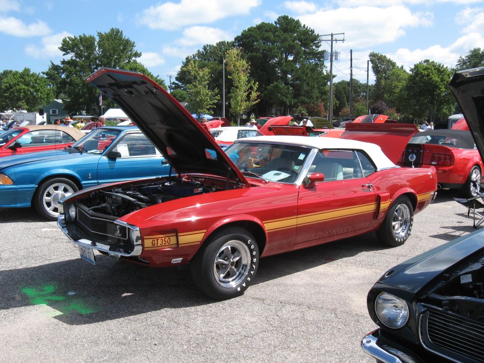 Red 1969 convertible with yellow stripe, hood open, GT350 badge