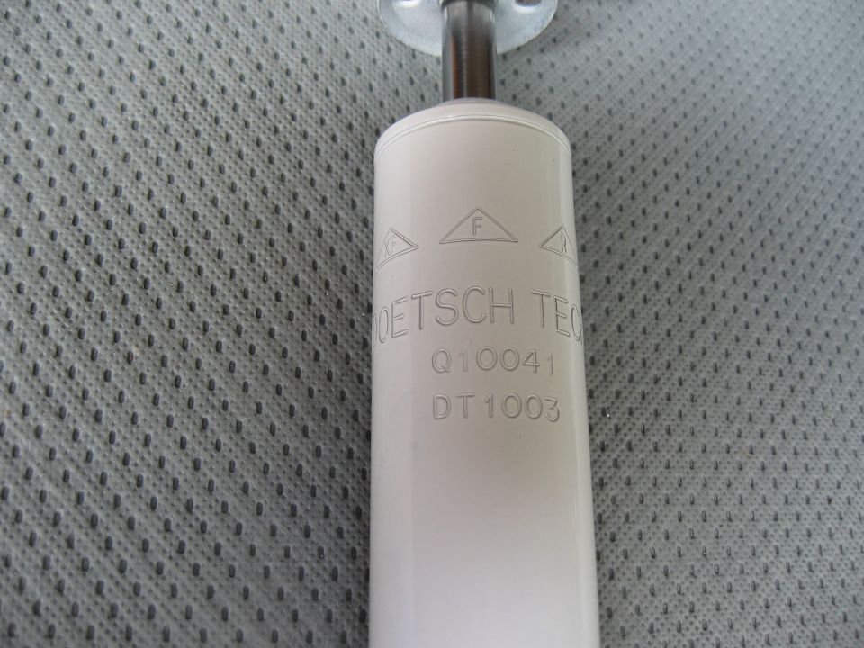 White shock absorber with DEUTSCH TECH Q10041 DT1003 stamped on it