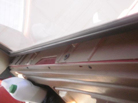 1991 Ford Bronco - A close-up view of the interior trim panel and a white bottle with a green cap.