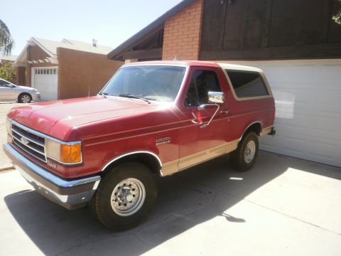 1991 Ford Bronco - This 1991 Ford Bronco is parked in front of a garage on a sunny day.