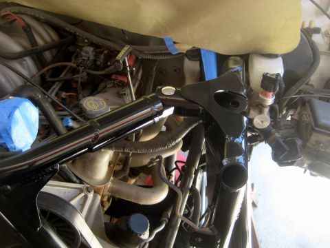 1996 Ford Bronco - Close-up of an engine bay showing a newly painted suspension part and various hoses.