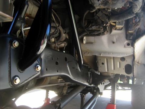 1996 Ford Bronco - Close-up view of a vehicle's undercarriage, focusing on the frame and suspension system.