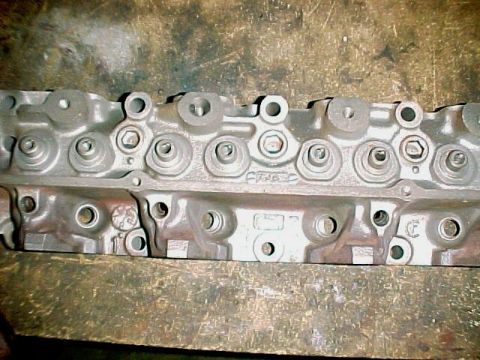 1968 Mercury Cougar - Close-up of an engine cylinder head, showing various ports and cast markings.