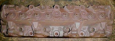 1968 Mercury Cougar - Close-up of a cast iron engine cylinder head, likely a replacement part.