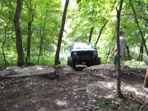 2005 Jeep Wrangler - Jeep Cherokee XJ navigating a challenging rocky off-road course.