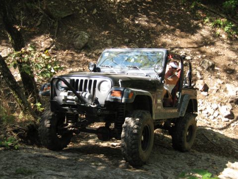 2005 Jeep Wrangler - A 2005 Jeep Wrangler navigates a challenging rocky terrain on an off-road trail.