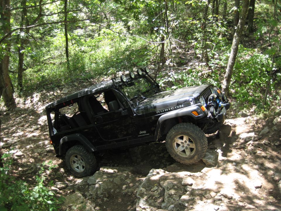 Black Jeep Wrangler Rubicon on rocky trail