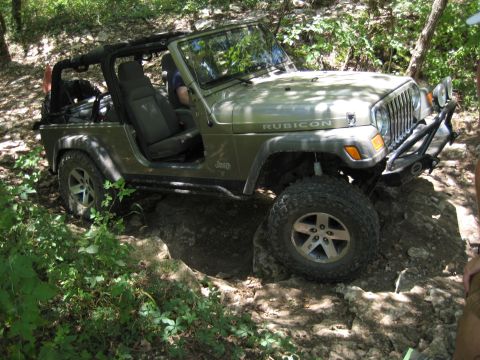 2005 Jeep Wrangler - Green 2005 Jeep Wrangler Rubicon navigating rocky terrain on an off-road trail.