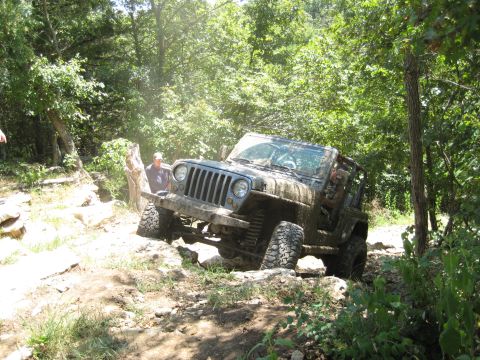 2005 Jeep Wrangler - Jeep Wrangler tackling a challenging off-road course on a sunny day.