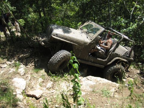 2005 Jeep Wrangler - Jeep Wrangler tackling a challenging off-road course on a sunny day.