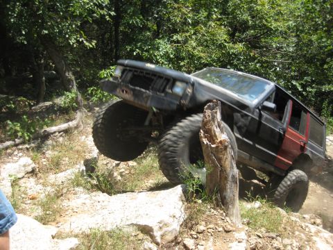 2005 Jeep Wrangler - A modified black Jeep Cherokee XJ navigates a rocky off-road course.