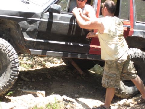 2005 Jeep Wrangler - Two men attempt to free a Jeep Cherokee XJ that is stuck on a rocky, off-road trail.