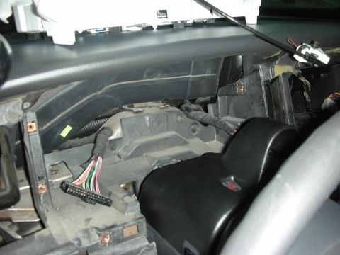 2004 Ford Crown Victoria - Exposed dashboard wiring and steering column components, likely during an installation or repair.