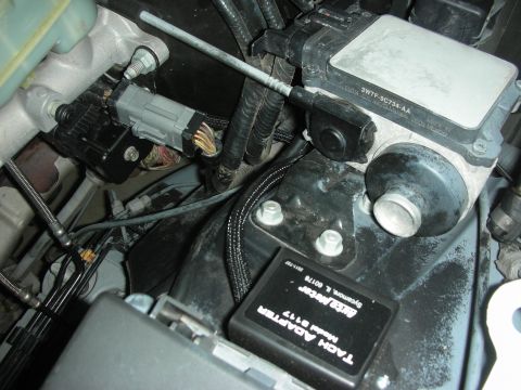 2004 Ford Crown Victoria - Close-up of an Auto Meter tach adapter, model 5117, installed in the engine bay.