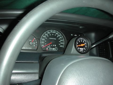 2004 Ford Crown Victoria - Interior view of a 2004 Ford Crown Victoria dashboard with an installed tachometer.