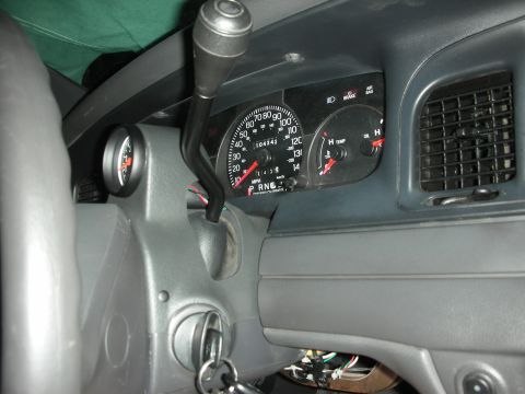 2004 Ford Crown Victoria - Gray interior dash shot of an instrument cluster reading 104,342 miles, with a 140 mph speedometer, temp and oil gauges, and BRAKE/AIR BAG…