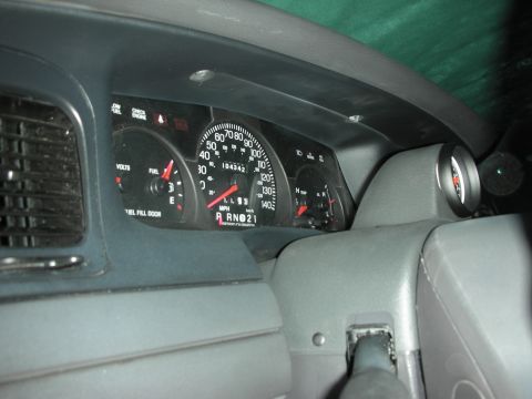 2004 Ford Crown Victoria - The dashboard of a 2004 Ford Crown Victoria shows the original instrumentation alongside an aftermarket Autometer tachometer.