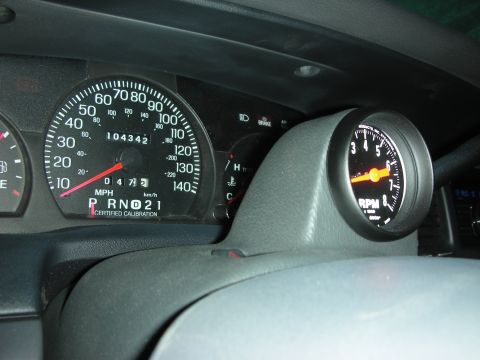 2004 Ford Crown Victoria - Instrument cluster of a Ford Panther-platform sedan showing a 140 mph 'CERTIFIED CALIBRATION' police-package speedometer with 104,342 miles…