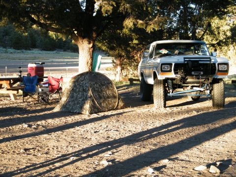 1982 Ford Bronco - A white 1978 Ford Bronco is parked at a campsite next to a tent and picnic table.