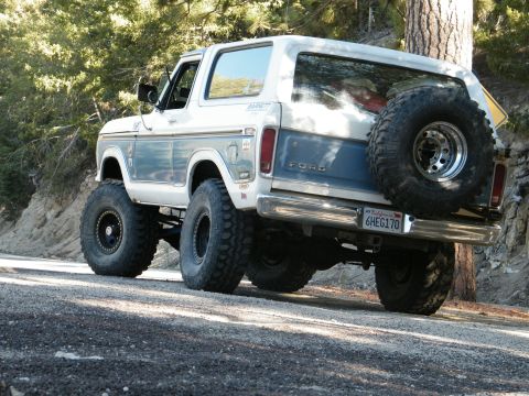 1982 Ford Bronco - Rear view of a lifted Ford Bronco with a spare tire mounted externally.