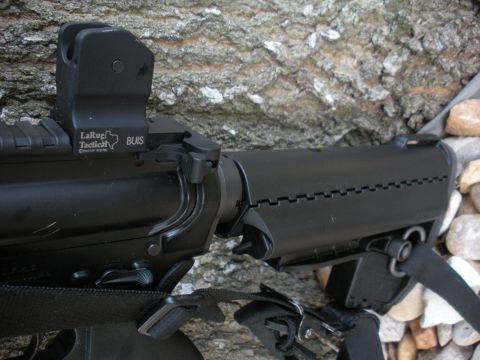 1996 Ford Bronco - Close-up of a LaRue Tactical BUIS sight on a rifle part, with a textured background.