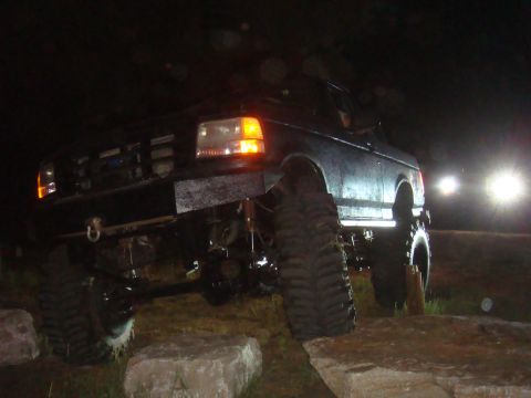 1992 Ford Bronco - Modified 1992 Ford Bronco navigating rough terrain under the cover of darkness.