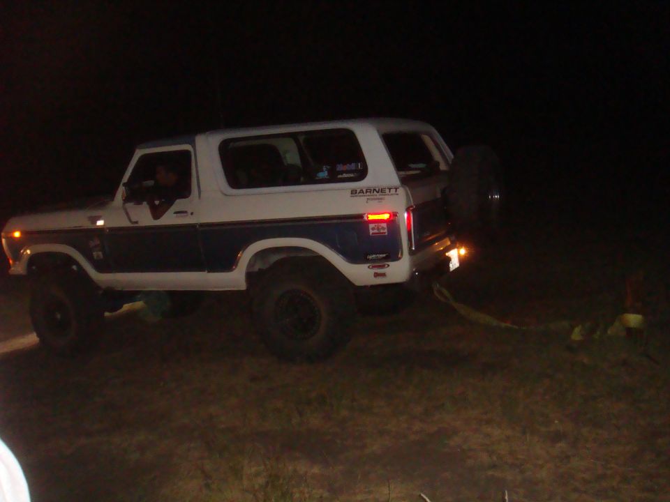 White and blue Ford Bronco, 1978 model, with spare tire on rear