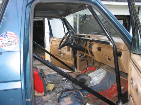 1986 Ford Bronco - Interior view of a 1986 Ford Bronco, modified with a roll cage and racing seats.