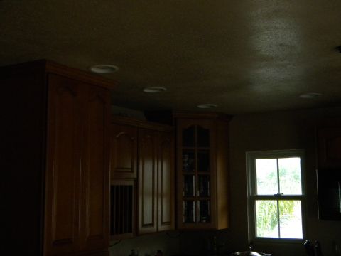 1992 Ford Bronco - Interior view of kitchen cabinets and a window with greenery visible outside.
