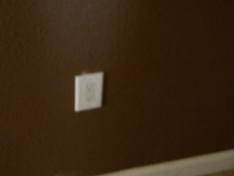 1992 Ford Bronco - A close-up view of an electrical outlet on a brown wall, with a website watermark visible.