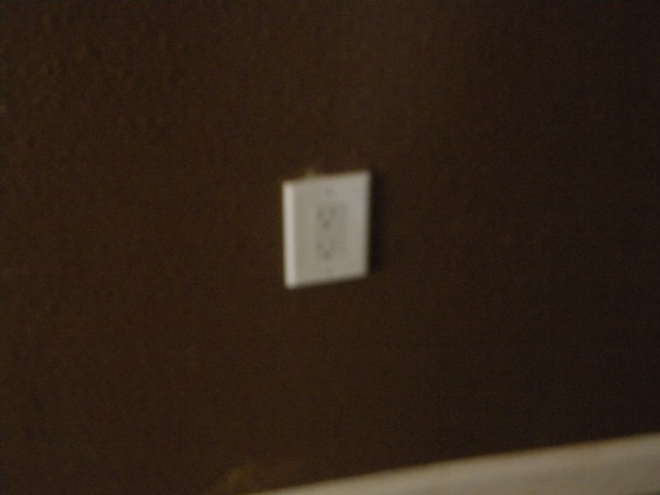 Electrical outlet on brown wall