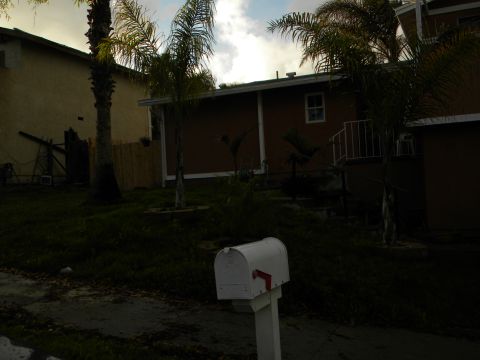 1992 Ford Bronco - A white mailbox stands in front of a residential house with palm trees under a cloudy sky.